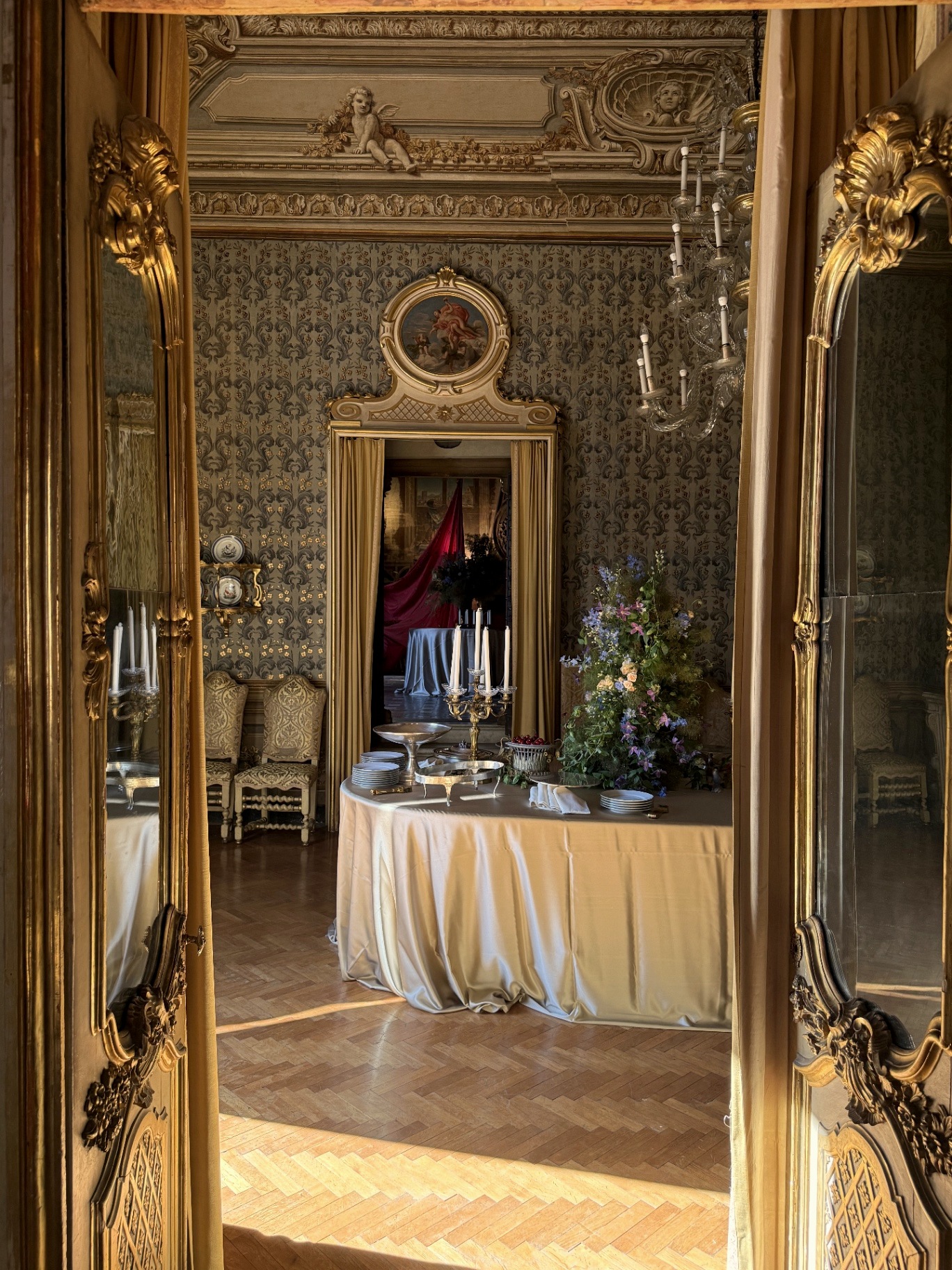 The gilded mirror room with cherub stucco