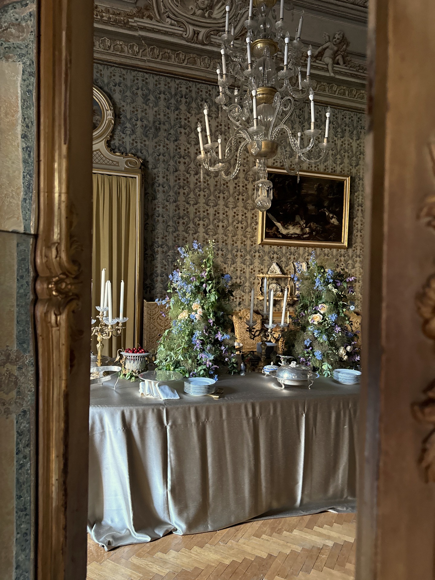 Wildflower arrangements on the silver-draped table