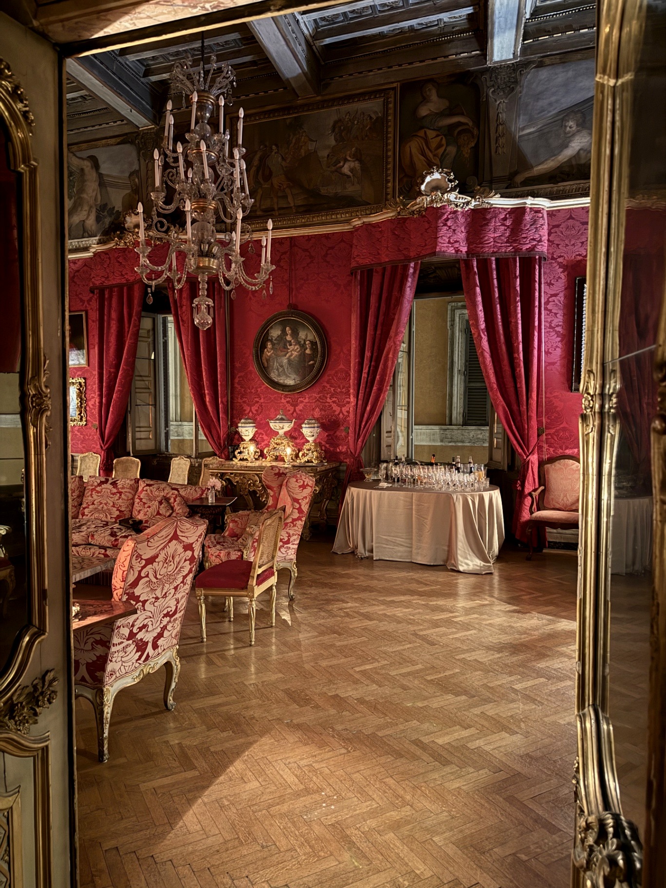 The crimson damask hall with crystal chandelier